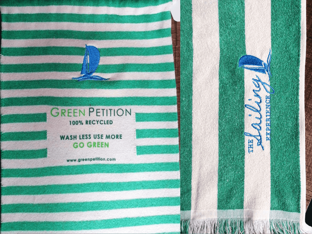 Eco-friendly striped towels featuring sailing logos, promoting sustainable practices and recycling.