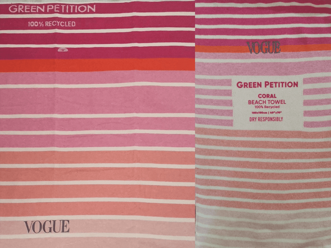Coral beach towel from Vogue, featuring vibrant pink and red stripes, made from 100% recycled materials.