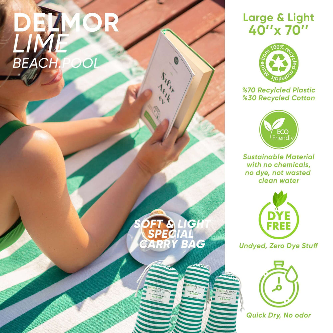 Delmor Lime Beach Towel (40"x70") on the beach with a person reading, featuring eco-friendly materials and a reusable carry bag.