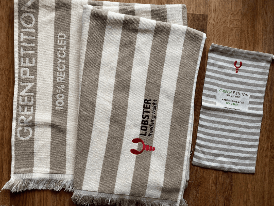 Eco-friendly recycled towels with striped design, featuring 'Green Petition' and lobster logo.