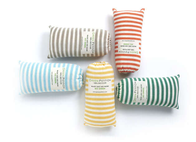 Colorful striped fabric pouches arranged in a circular pattern, showcasing eco-friendly designs and labels.