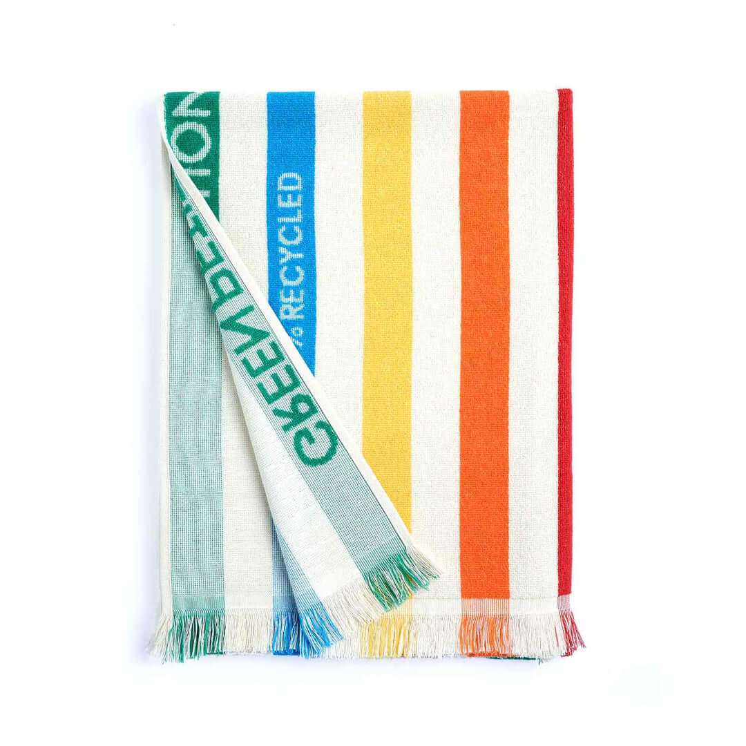 Multicolored striped blanket featuring recycled materials, perfect for cozying up or outdoor picnics.