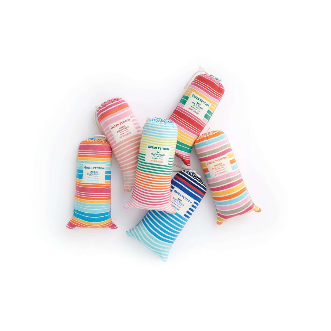 Colorful striped fabric pillows in various shades, creating a vibrant display for home decor.