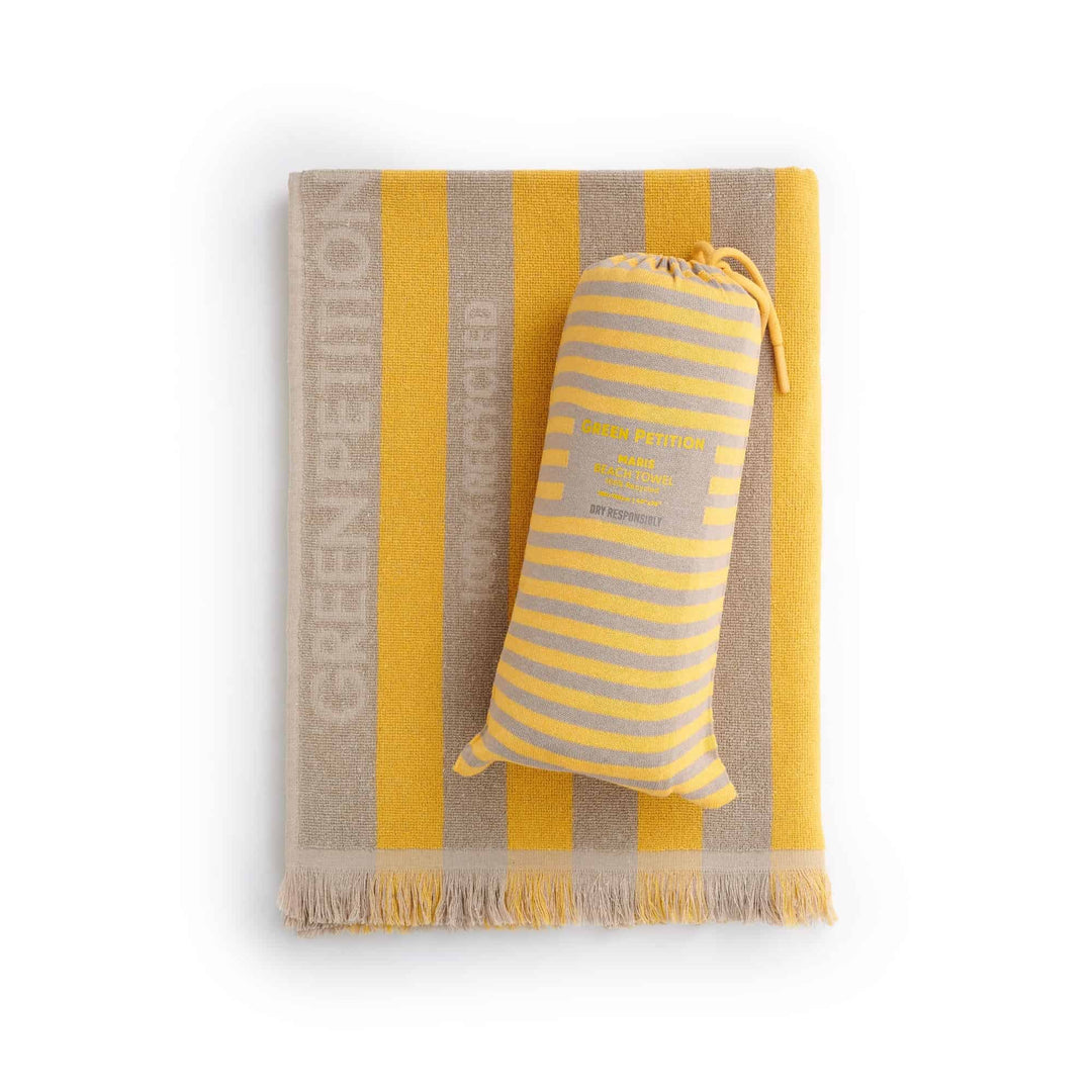 Maris Amber Beach Towel in striped yellow and cream colors, showcasing sustainable comfort and timeless design.