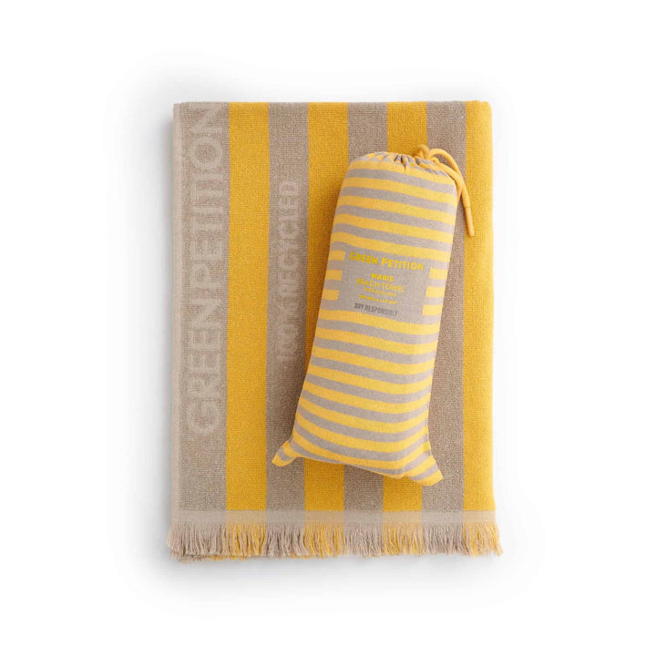 Maris Amber Beach Towel in striped yellow and cream colors, showcasing sustainable comfort and timeless design.