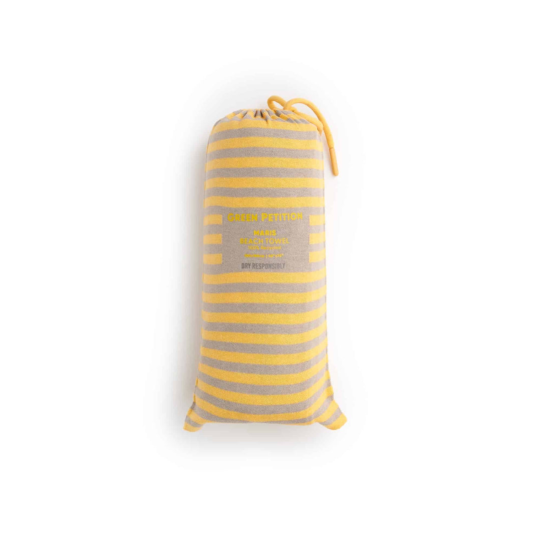 Maris Amber Beach Towel in classic yellow stripes, combining sustainable luxury and timeless design.