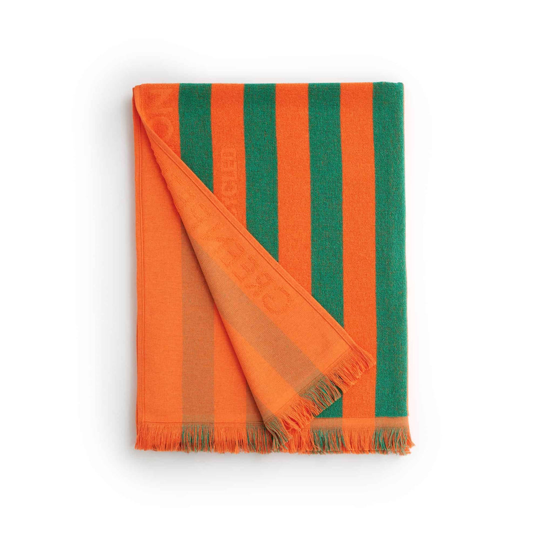 Maris Jade Beach Towel featuring vibrant orange and green stripes, perfect for sustainable comfort at the beach.