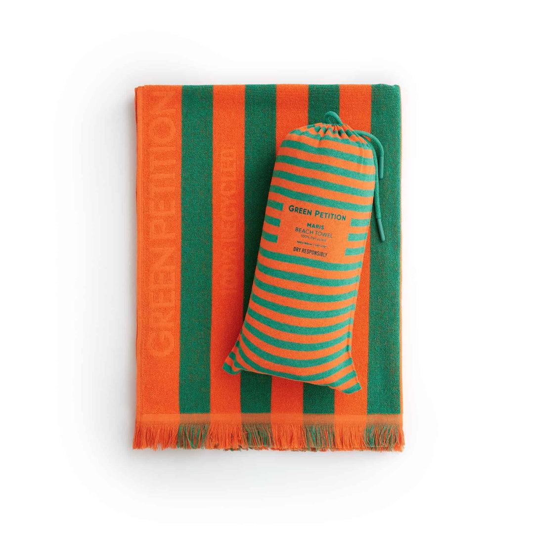Maris Jade Beach Towel in vibrant orange and green stripes, promoting eco-friendly luxury and sustainable comfort.