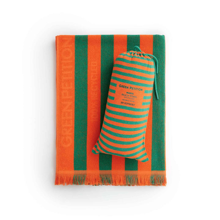 Maris Jade Beach Towel in vibrant orange and green stripes, promoting eco-friendly luxury and sustainable comfort.