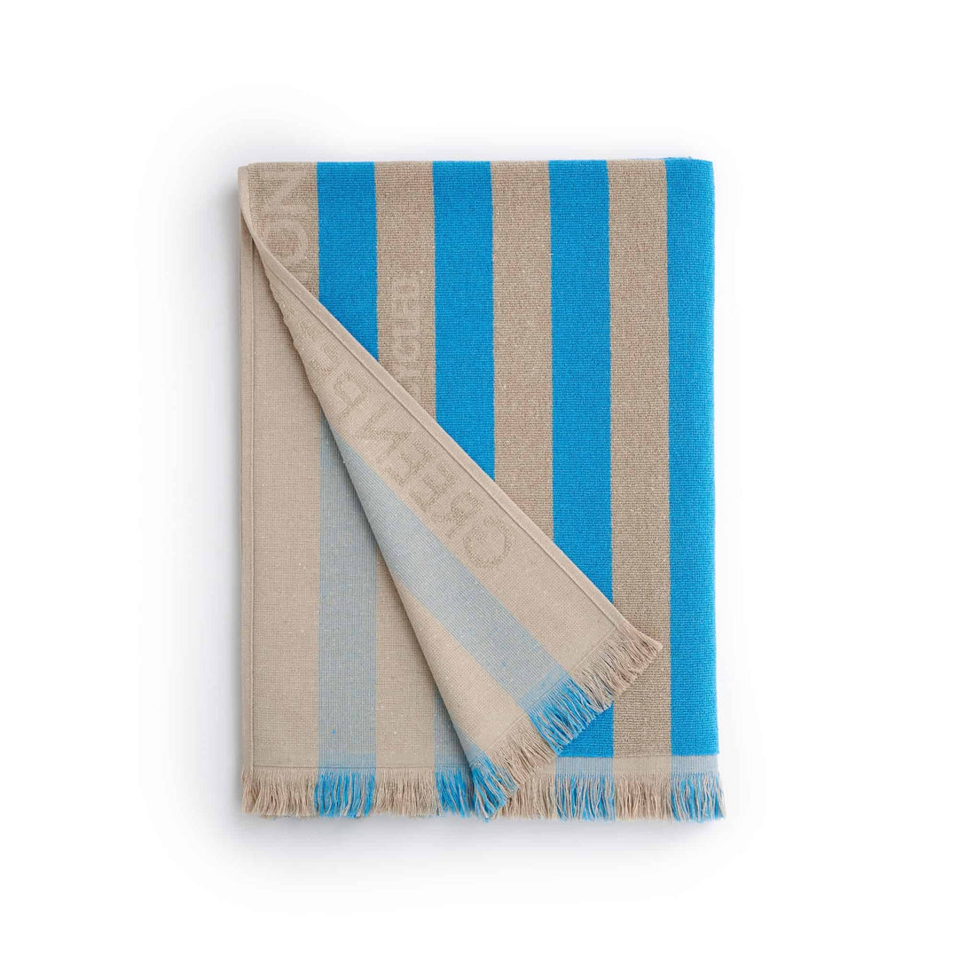 Maris Laguna Beach Towel featuring timeless blue and beige stripes, crafted for eco-conscious luxury and comfort.