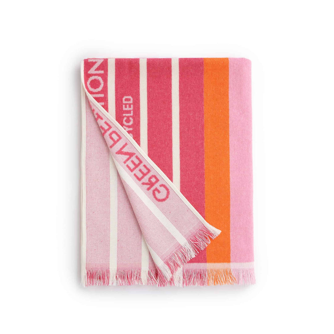 Ocean Coral Candy Beach Towel in vibrant pink and orange stripes, made from recycled materials for eco-friendly comfort.