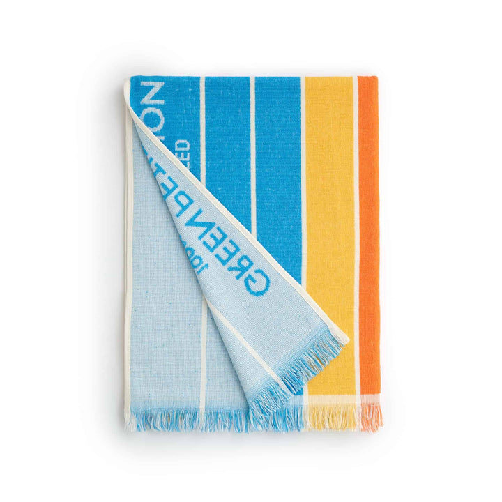 Ocean Lagoon Aqua Beach Towel folded, showcasing eco-friendly colors of blue, yellow, and orange stripes.