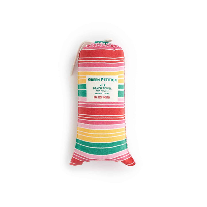 Eco-friendly striped beach towel in carrying bag, made from recycled materials, vibrant colors, portable for travel.