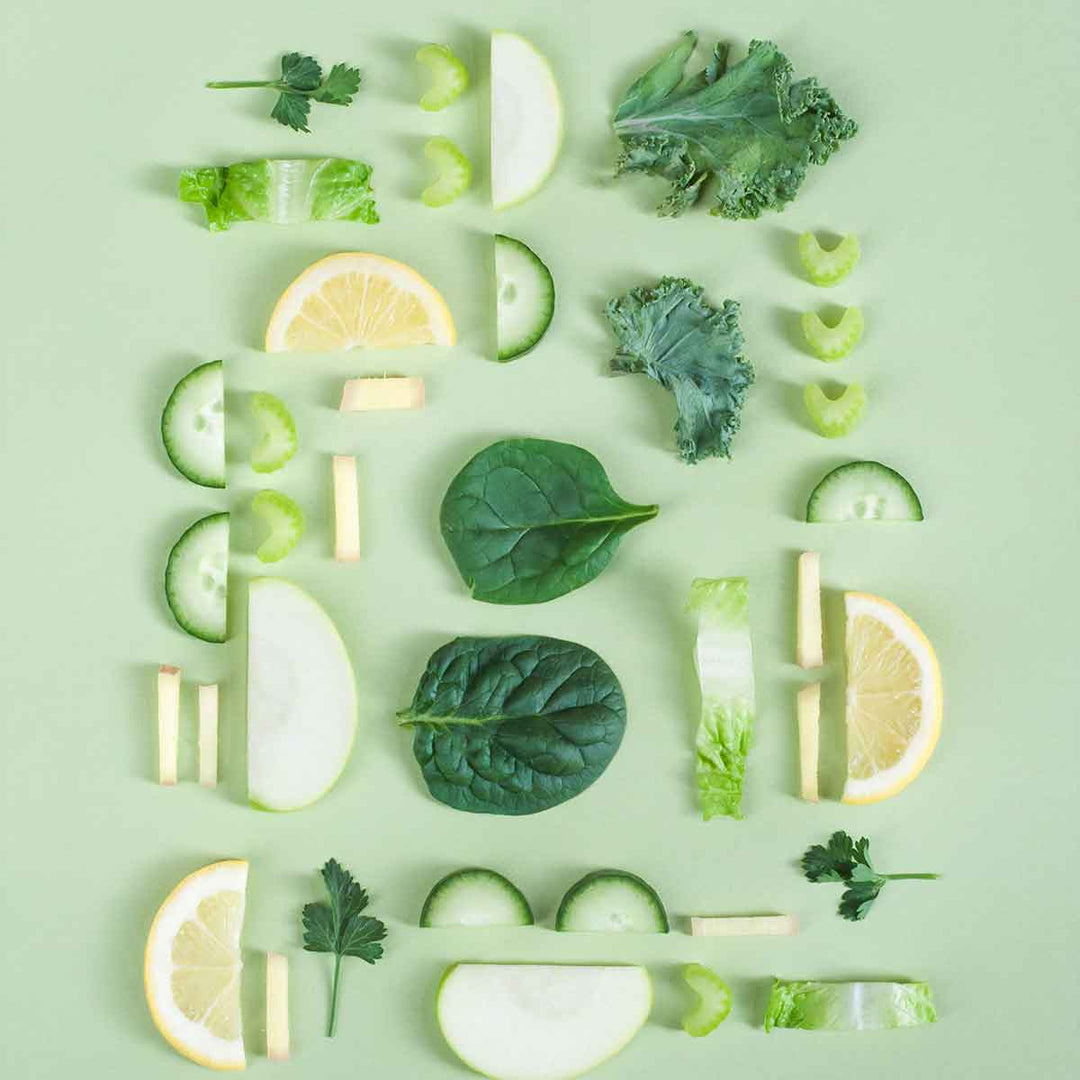Colorful arrangement of fresh vegetables and fruits on a green background showcasing a zero waste lifestyle.